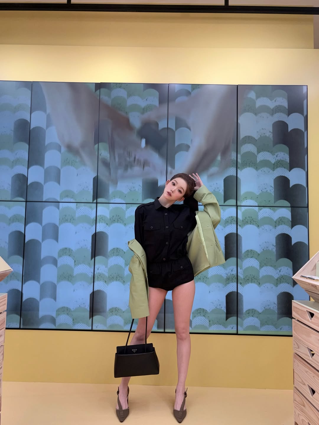 Close-up of Tsuki's slicked-back hairstyle and Prada accessories, highlighting her doll-like features and high-fashion makeup.