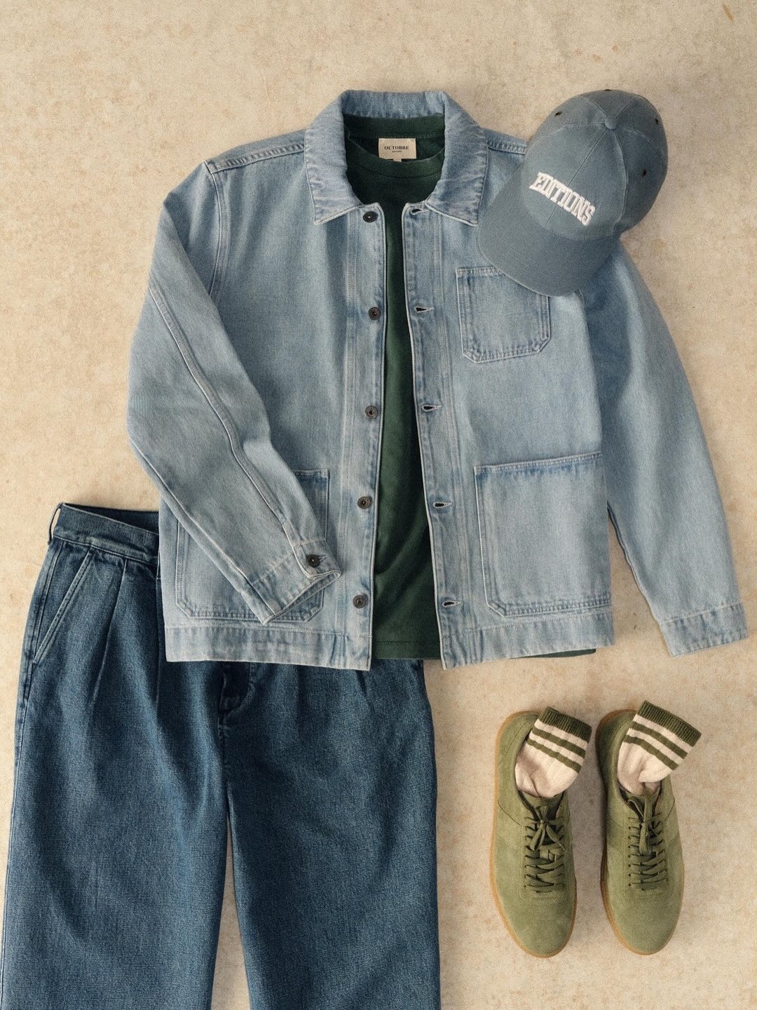 A collection of Octobre Éditions leather goods and accessories displayed in a rustic, chic setting.