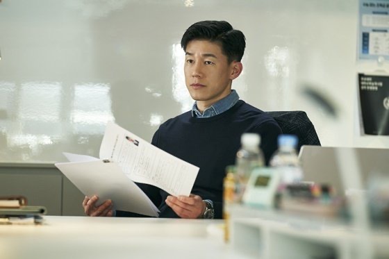 The intense and professional gaze of Kim Mu-yeol in a suit.