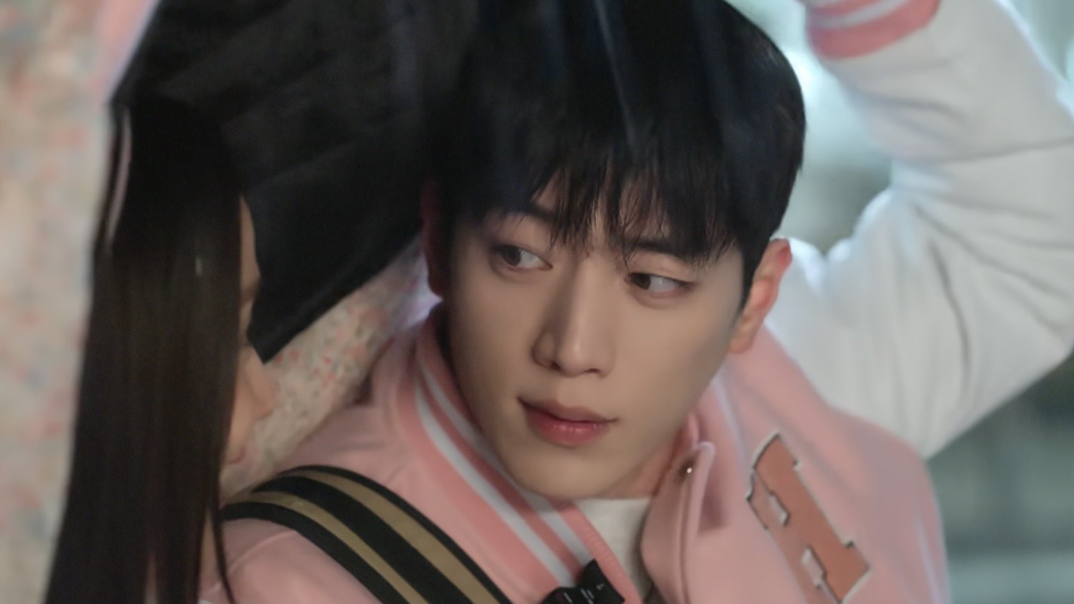 Seo Kang-joon looking off into the distance, deep in thought, with soft lighting.
