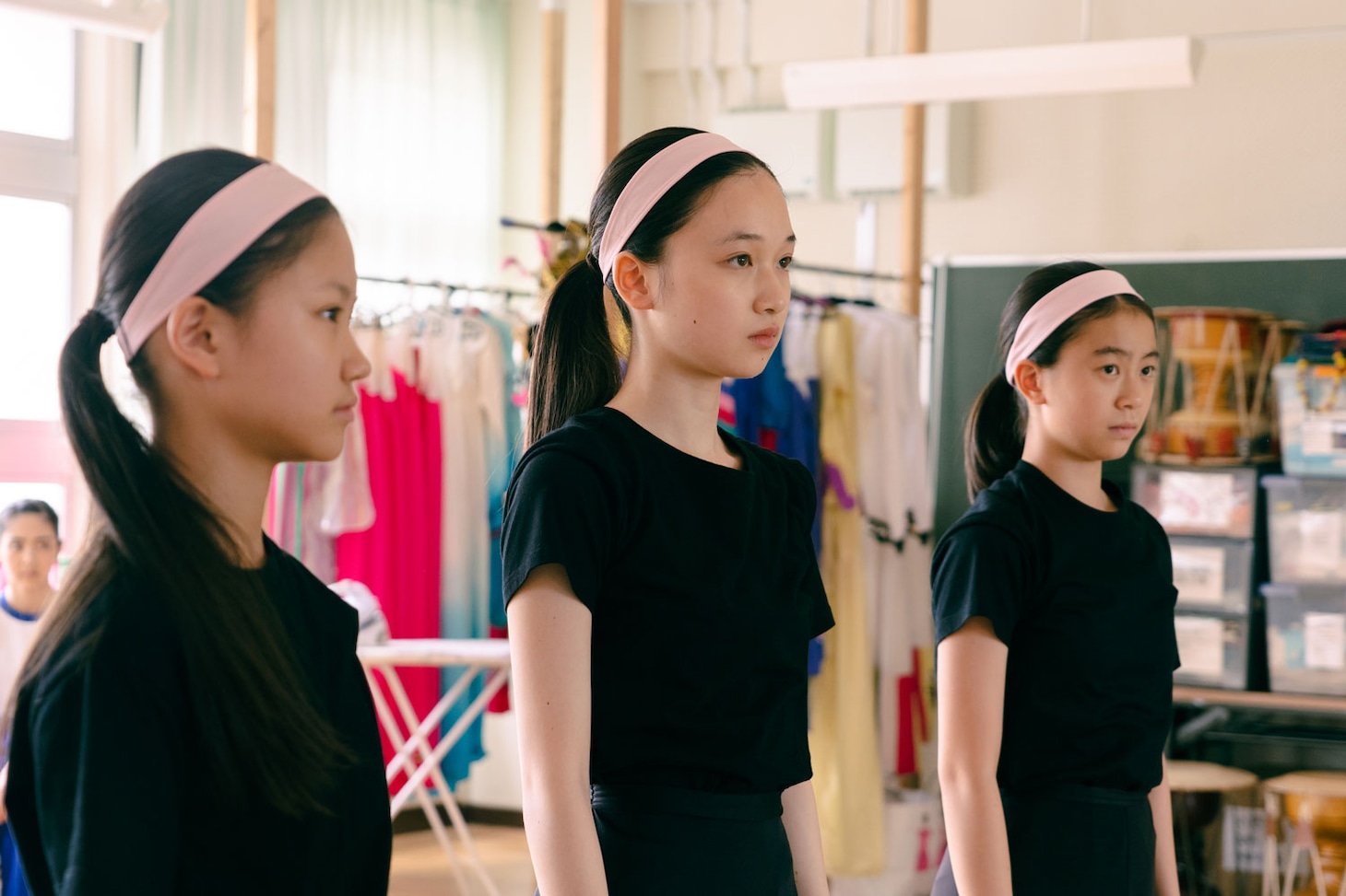 A close-up shot of the protagonist's hands holding the titular trophy, highlighting the contrast between the shiny award and the character's tense posture.