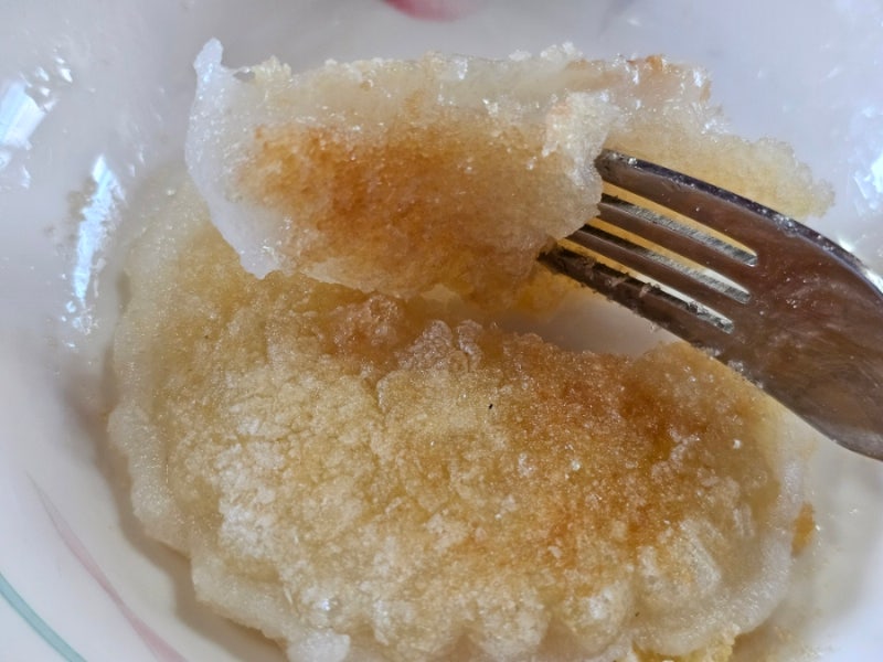 A close-up shot of Jeju Jireum-tteok, a star-shaped fried rice cake coated in sparkling white sugar.