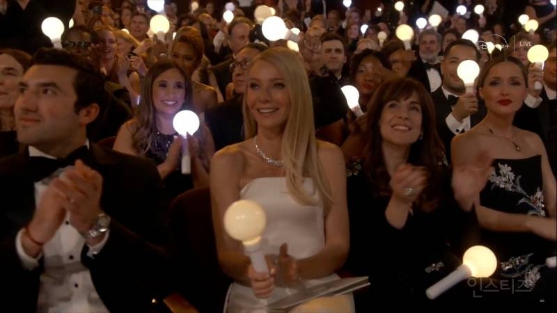 A sea of lightsticks at a concert, showing the power of synchronized lighting.