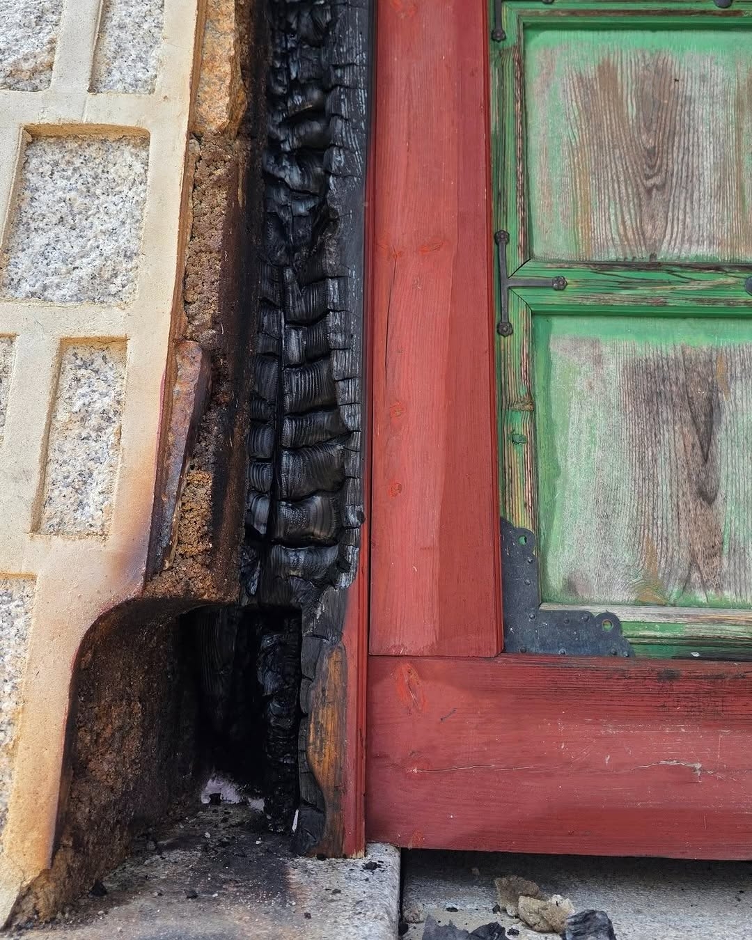 A wide shot of the Gyeongbokgung Palace grounds during the early morning investigation by fire officials.