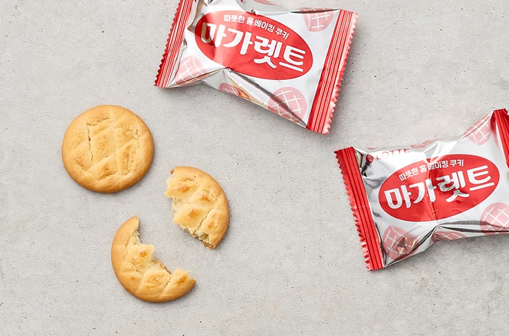 A box of Sablé cookies, showing the golden-brown, round biscuits with a slightly crumbly texture.