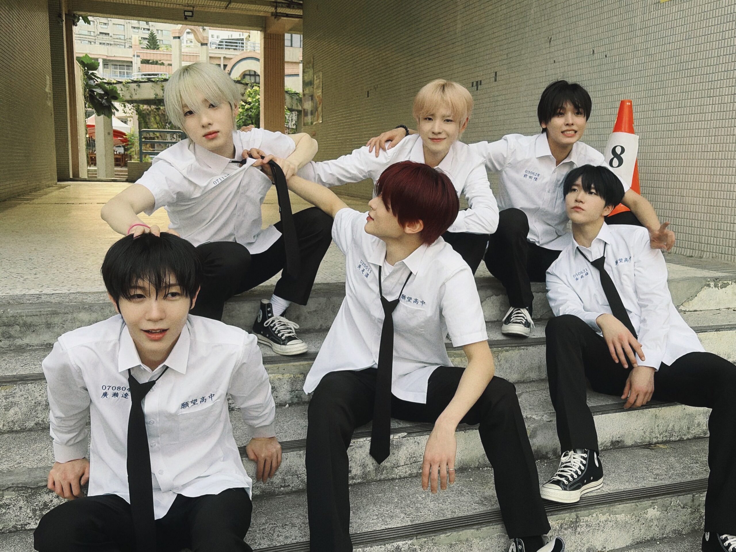 NCT WISH members posing in Taiwan school uniforms for their Kaohsiung tour