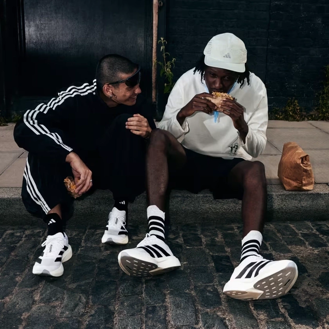 The Adidas Evo SL in a crisp white and silver colorway showing its sleek aerodynamic profile.