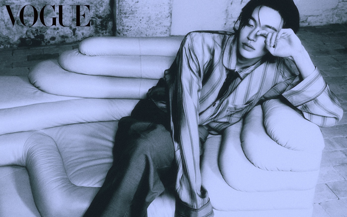 Wonbin in a dramatic pose for Vogue Korea, highlighting the movement of the Saint Laurent summer fabrics