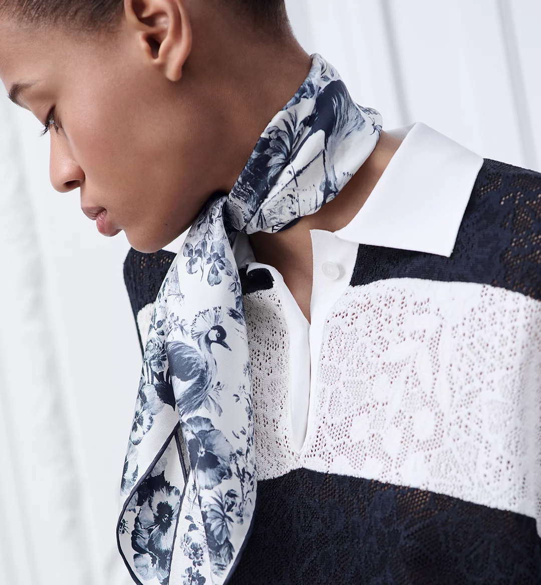 Close up of Dior silk scarf with detailed botanical illustrations and soft color palette