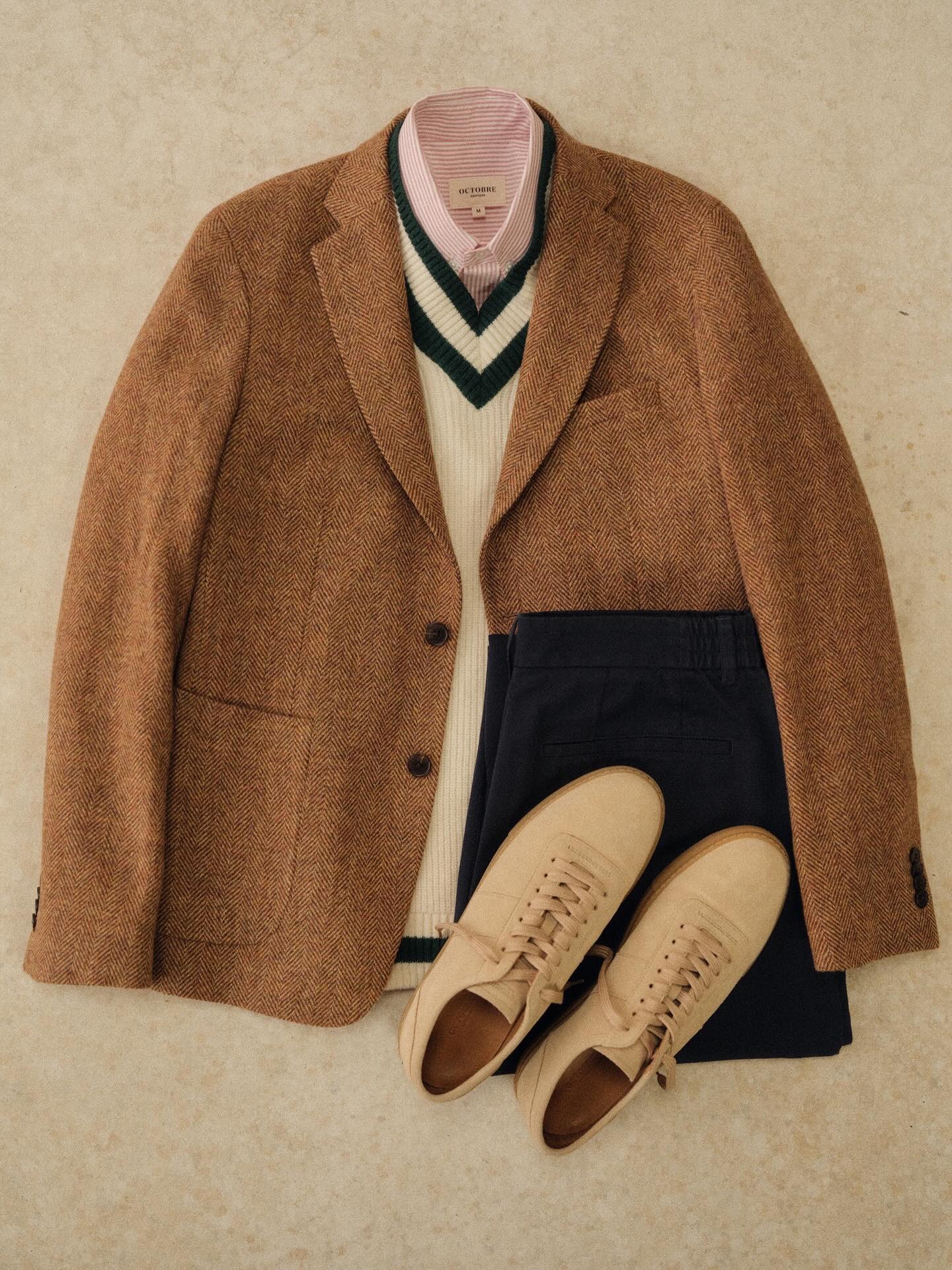 A stylish man wearing a textured Octobre Éditions knit sweater and trousers, looking effortlessly French.