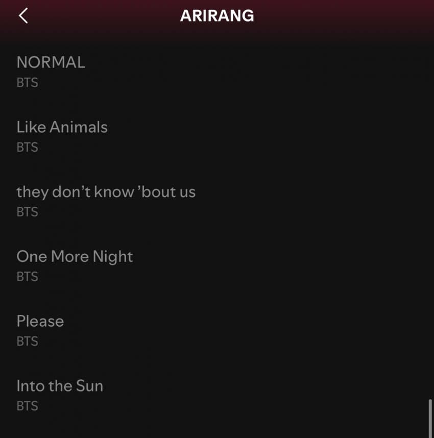A wider screenshot of a Spotify album page, showing the artist name, album art (blurred), and a list of 14 tracks.