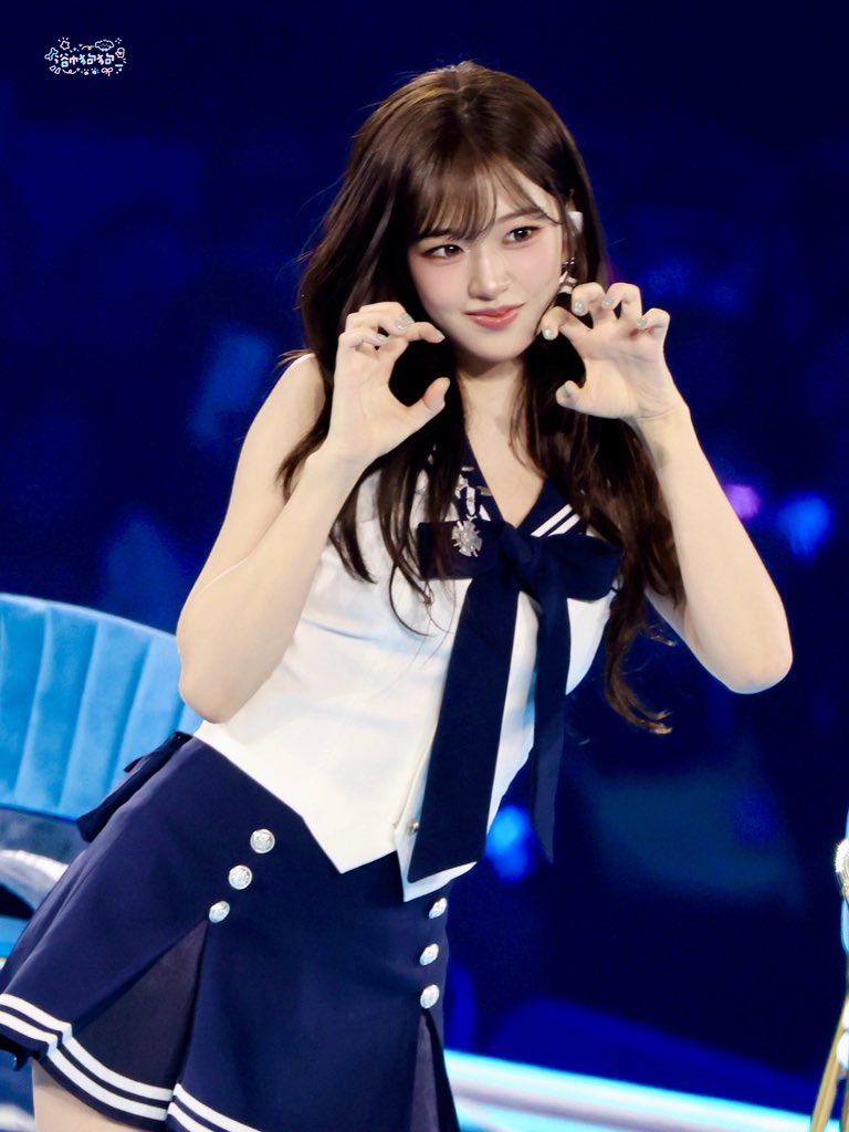 Side profile of An Yujin highlighting the 'perilla leaf' bangs and the rich brown hair color.