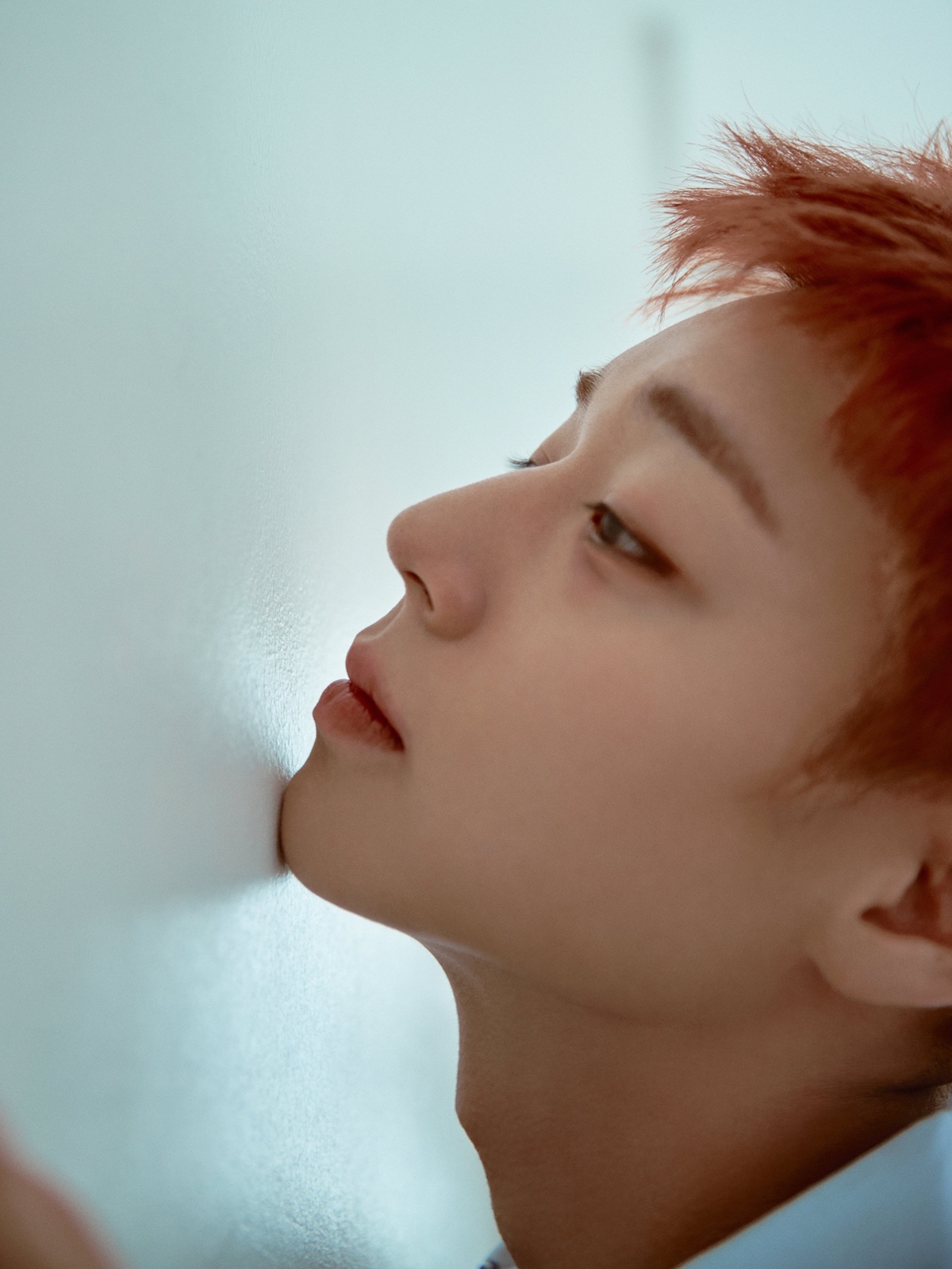 Park Ji Hoon posing in a dark, structured outfit for his 1st Single Album RE:FLECT