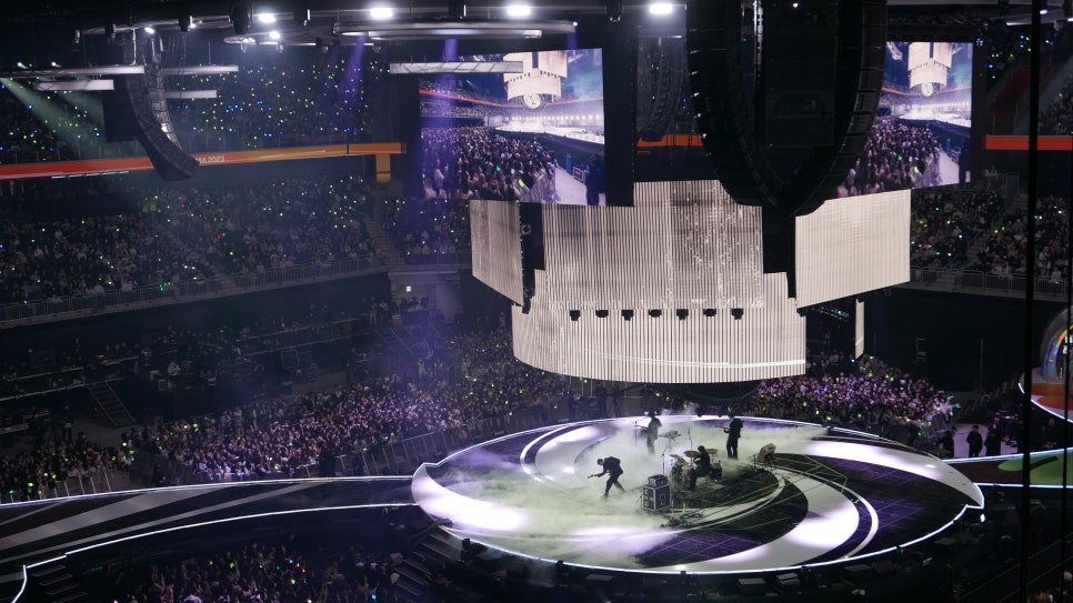 The interior of Inspire Arena showing the stage and seating configuration with high-tech lighting.