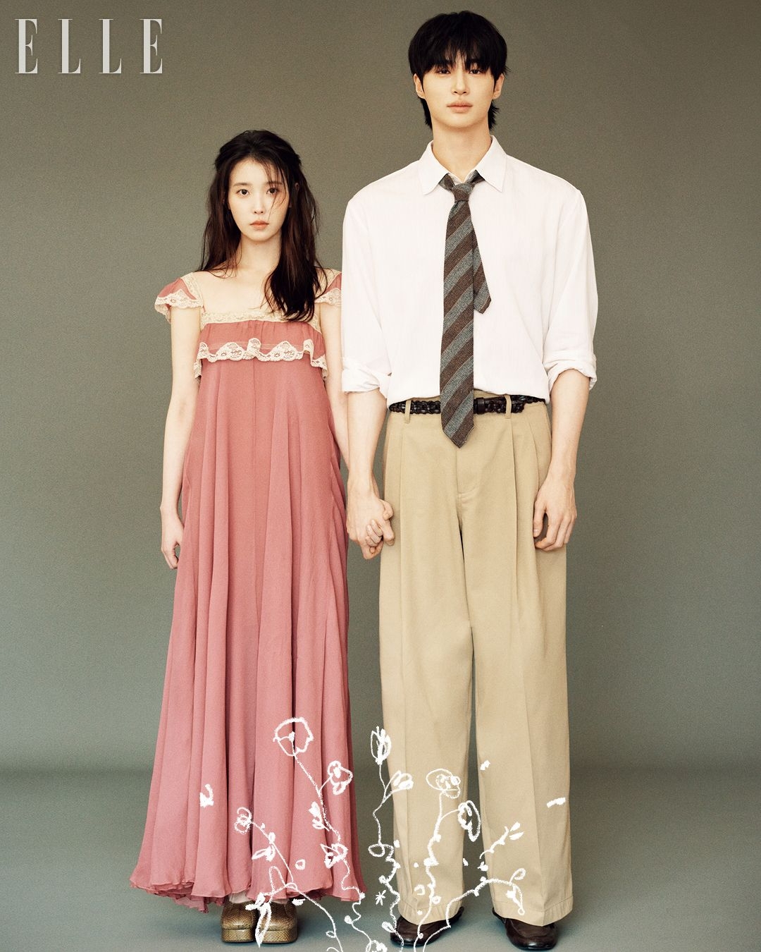 IU and Byeon Woo-seok posing in a high-fashion wedding aesthetic for Elle Korea