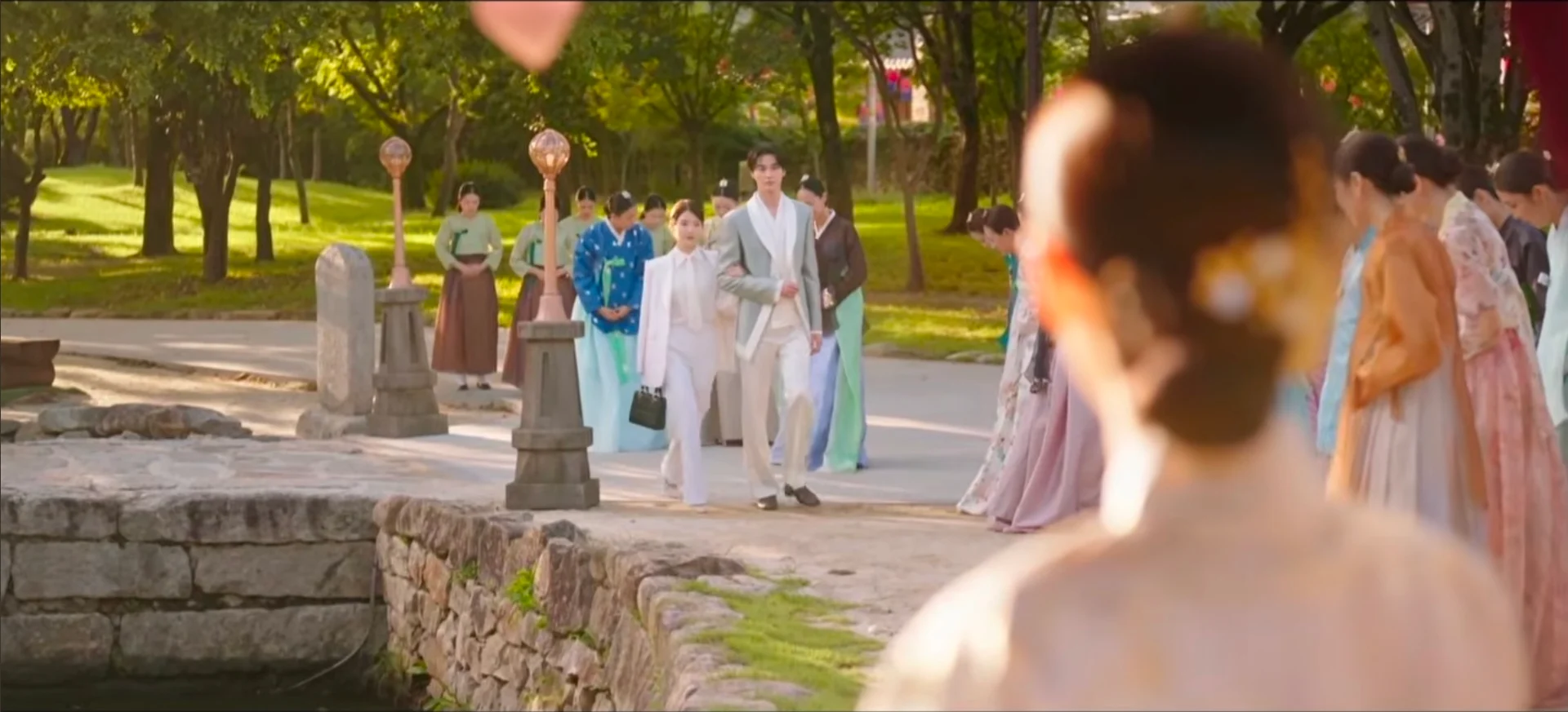 Byeon Woo-seok and IU standing together in a wide shot showing their significant height difference in the drama Dae-gun Bu-in