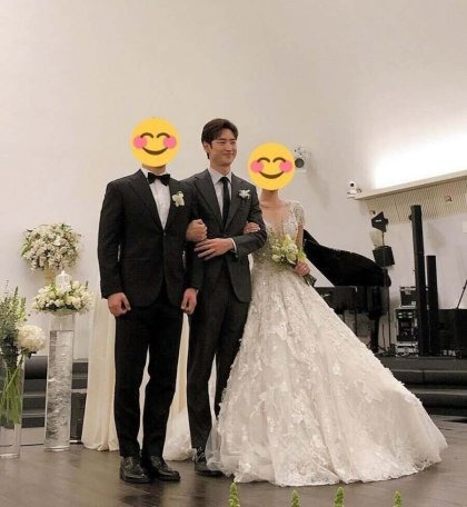Candid shot of Lee Je-hoon interacting with guests at a wedding hall